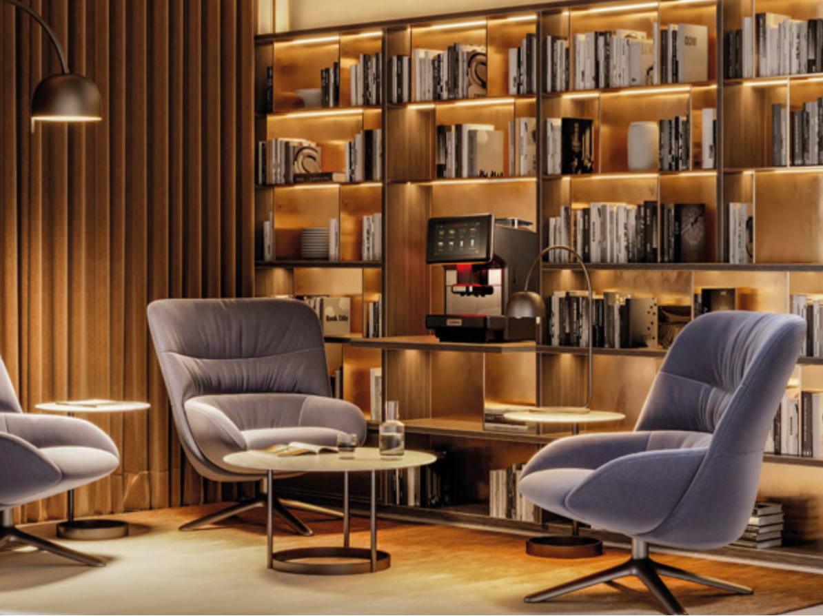 La Cimbali S-Lite Espresso Machine in a luxury lounge with bookshelves and designer seating - S-Lite Espresso Machine for Luxury Lounges & Hospitality Spaces | La Cimbali - Designed for premium environments, the S-Lite by La Cimbali delivers precision brewing and aesthetic harmony in any upscale lounge or library.